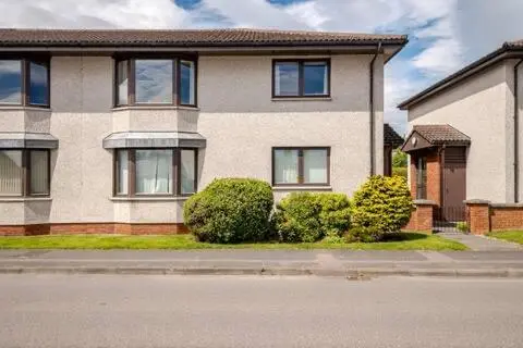 a house with bushes in front of a street at Number 5, Muirfield Court in Inverness