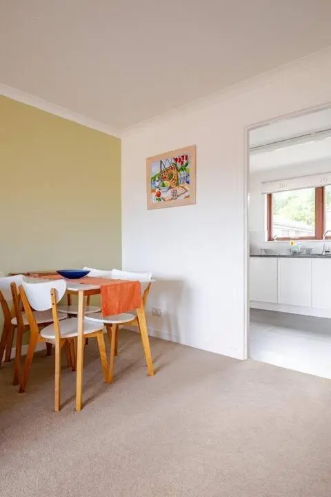 a dining room with a table and chairs at Number 5, Muirfield Court in Inverness