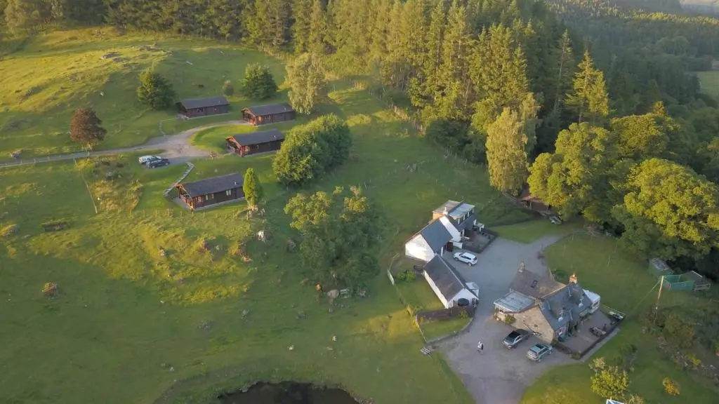 an aerial view of a farm with a group of buildings at Highgarry Lodges in Invergarry