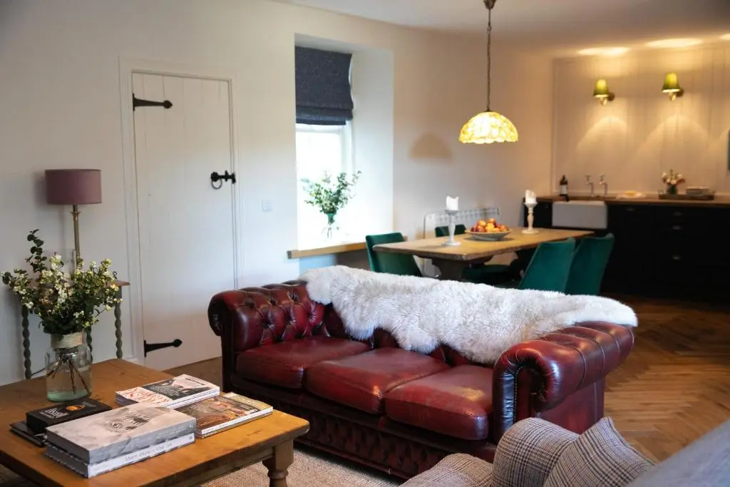 a living room with a couch and a table at Dandaleith Cottage No.1 in Craigellachie