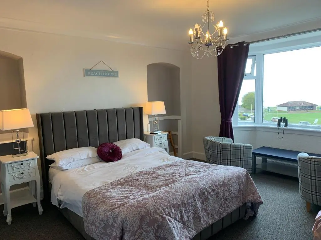 a bedroom with a bed and a large window at "Stunning Sea-Views" at Wetherby Nairn in Nairn