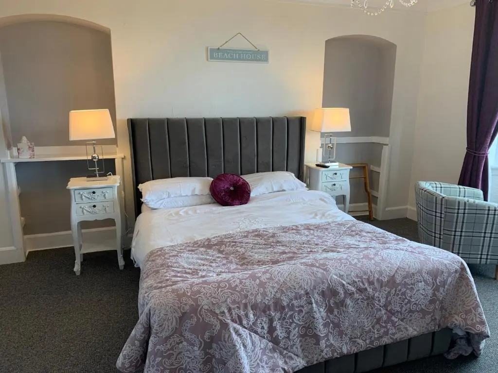 a bedroom with a bed with a purple pillow on it at "Stunning Sea-Views" at Wetherby Nairn in Nairn