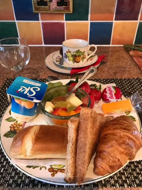 a plate of food with bread and a cup of coffee at Inchrye Bed & Breakfast in Inverness