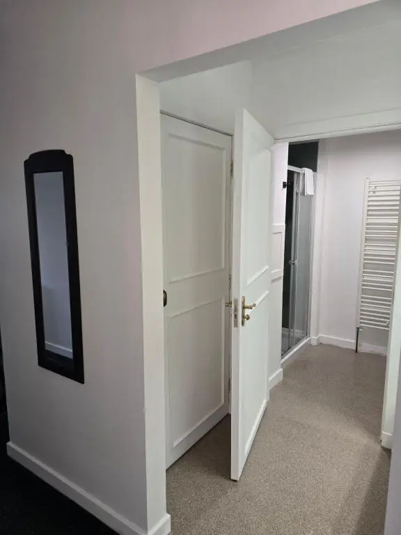 an empty room with a mirror and a door at The Red Lion Tavern in Fochabers
