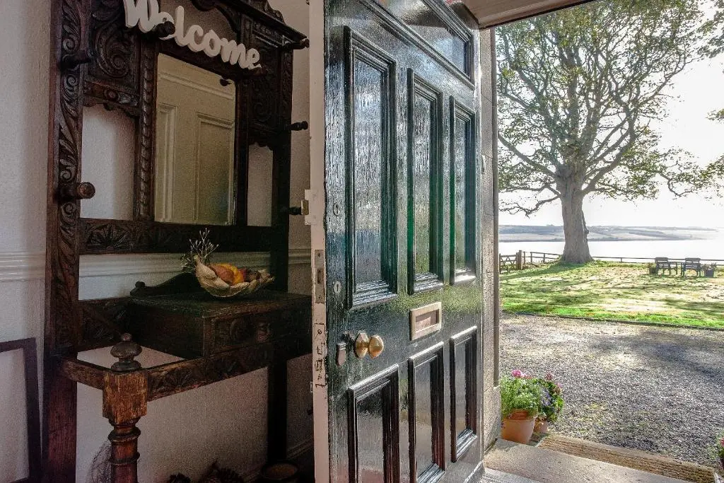 a door to a house with a view of a yard at Kiltearn Guest House in Evanton