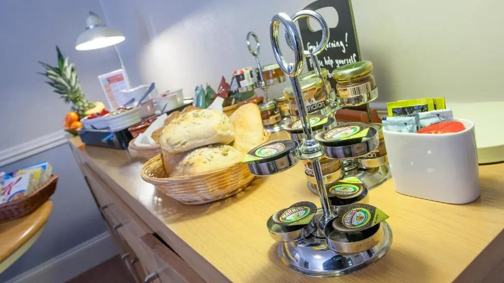 a buffet with bread and other foods on a table at Kiltearn Guest House in Evanton