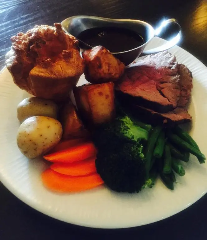 a plate of food with meat potatoes vegetables and sauce at Chieftain Hotel in Inverness