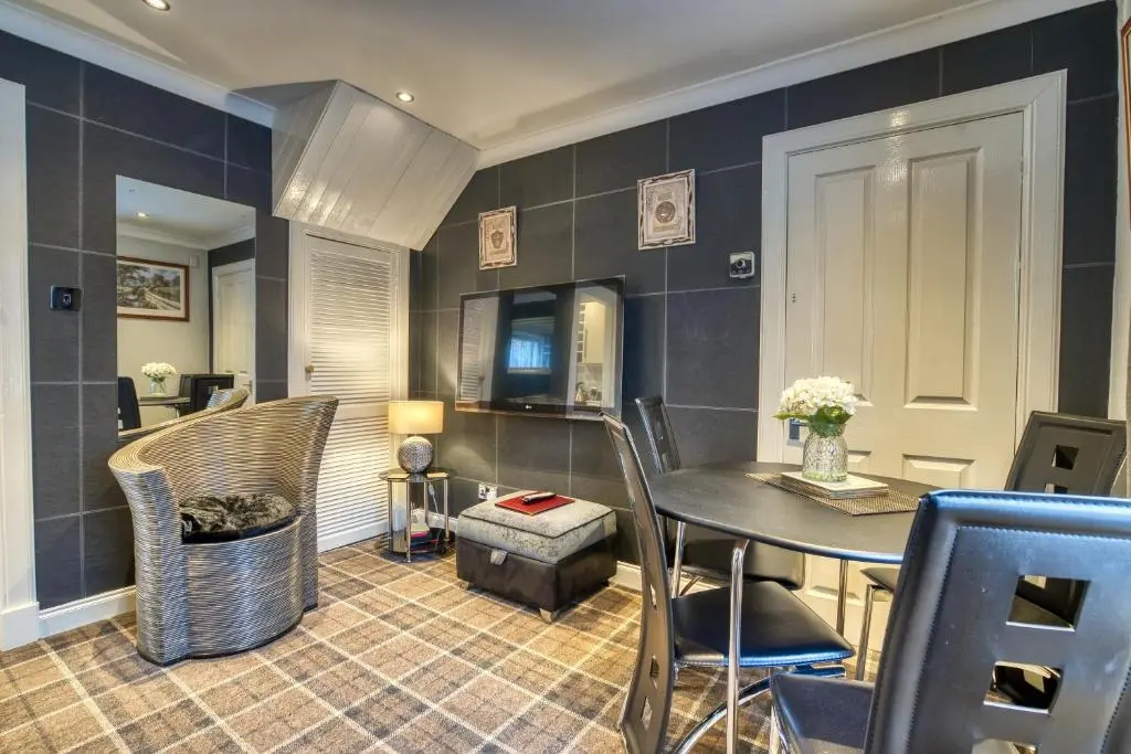 a dining room with a table and chairs at Pitfaranne Guest House in Inverness