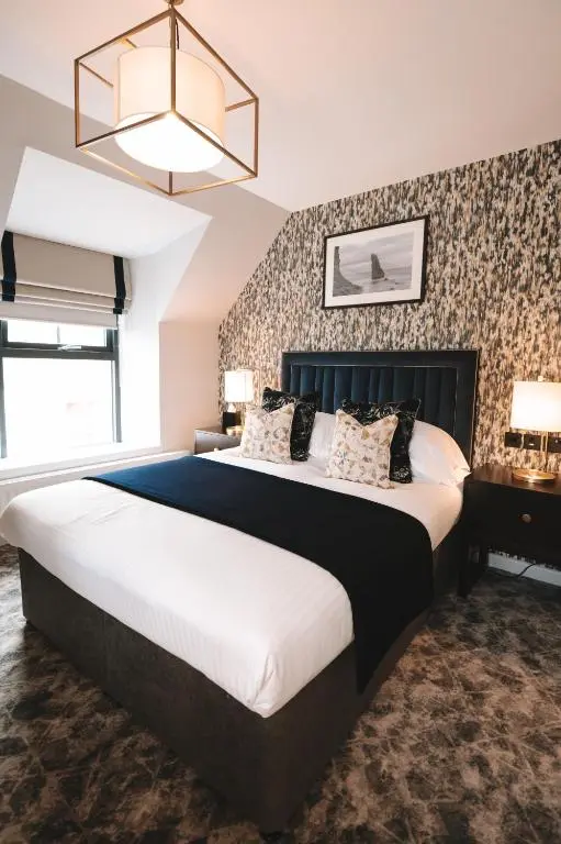a bedroom with a large bed in a room at The Seafield Arms-Cullen in Cullen