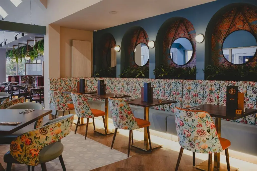 a restaurant with tables and chairs and mirrors at The Seafield Arms-Cullen in Cullen