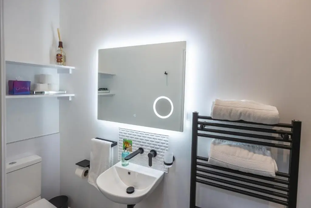a white bathroom with a sink and a toilet at Aye Stay in Inverness
