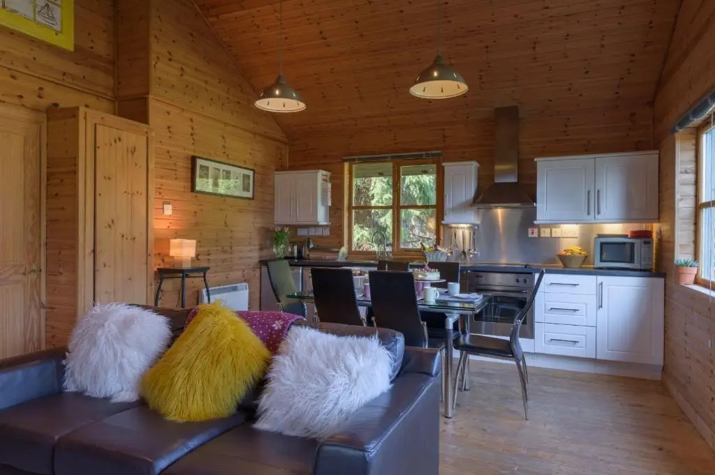 a living room with a couch and a kitchen at Ben Macdui in Banchory