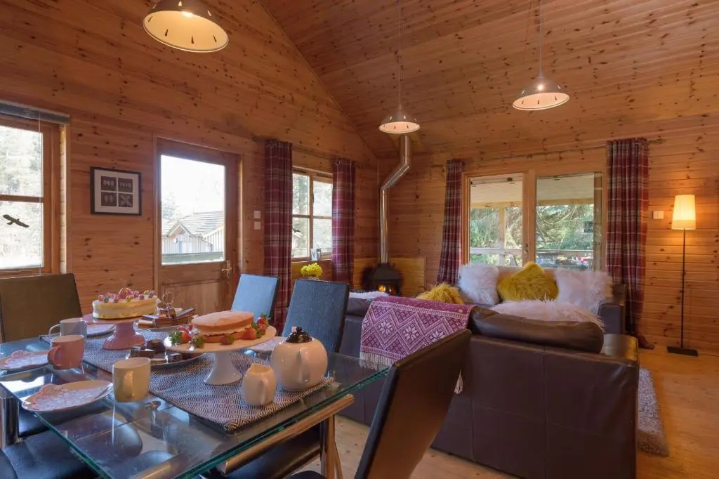 a living room with a table and a couch at Ben Macdui in Banchory