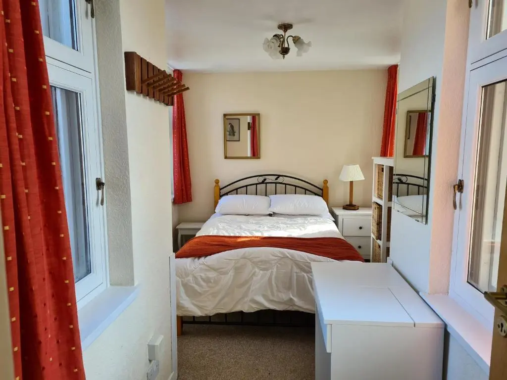 a small bedroom with a bed and a window at Skye Cottage, Meadowside House, near Kingussie in Kingussie