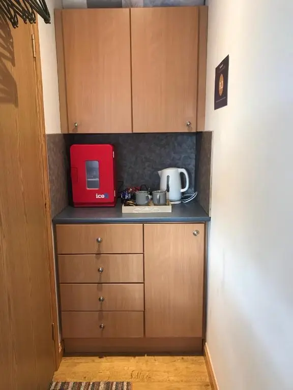 a kitchen with a red appliance on a counter at Exclusive Private double room, en-suite wet room Private entrance in Forres