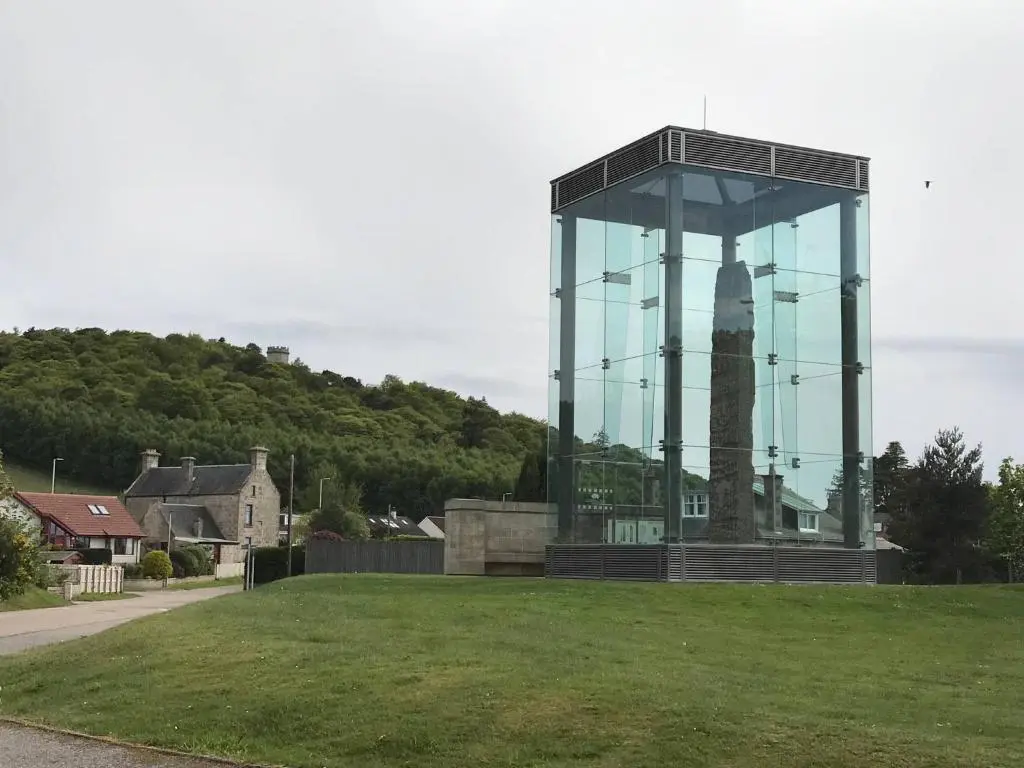 a building with a clock tower in the middle of a field at Exclusive Private double room, en-suite wet room Private entrance in Forres