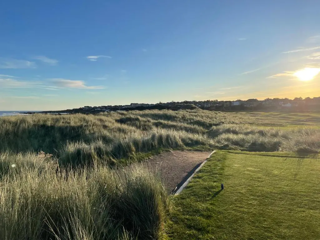 a dirt road through a field of grass at Cliffside in Lossiemouth
