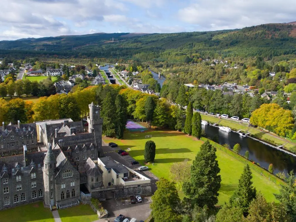 an aerial view of a castle and a town with a river at Old School 10 Apartment With A View in Fort Augustus