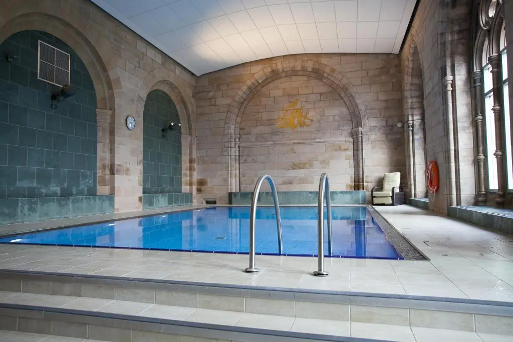 a large swimming pool in a large building at Old School 10 Apartment With A View in Fort Augustus