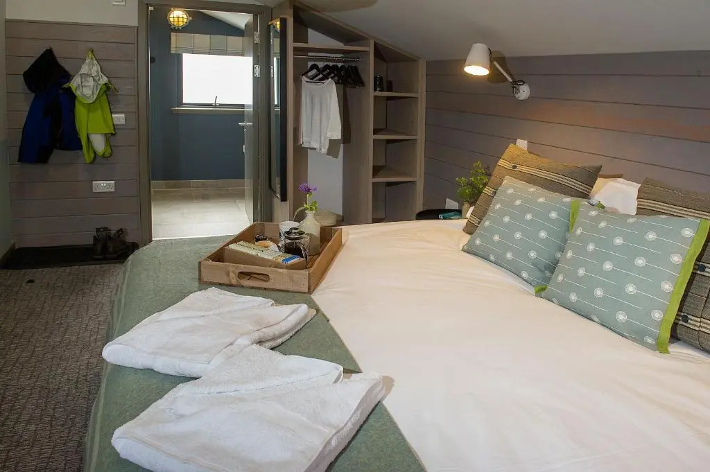 a bedroom with a bed with white towels on it at Lock Chambers, Caledonian Canal Centre in Fort Augustus