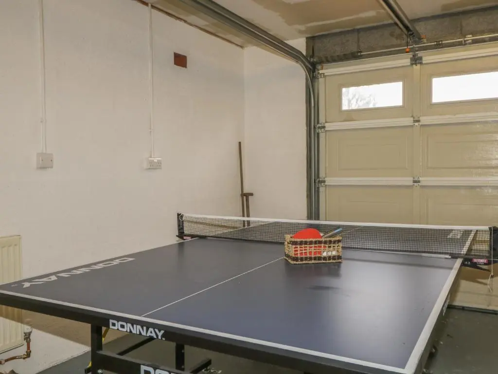 a ping pong table in a room with at Number 11 in Beauly