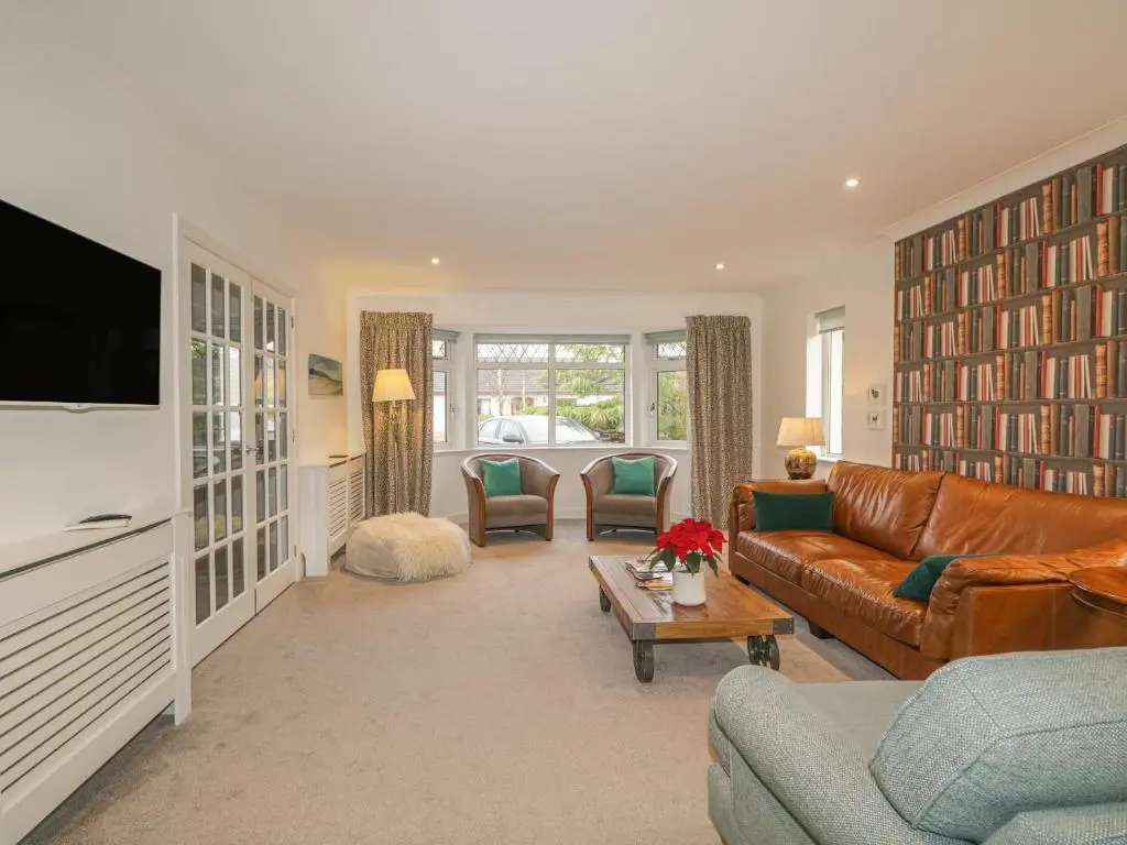 a living room with a couch and a tv at Number 11 in Beauly