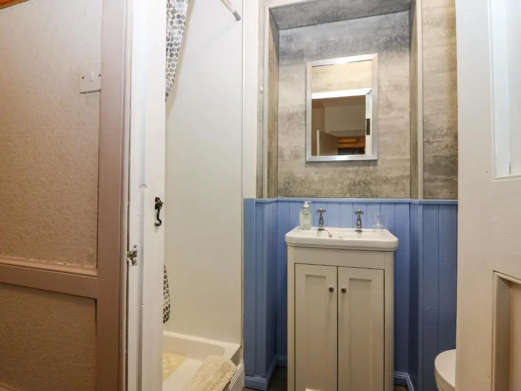 a bathroom with a sink and a mirror at The Bothy in Kirriemuir