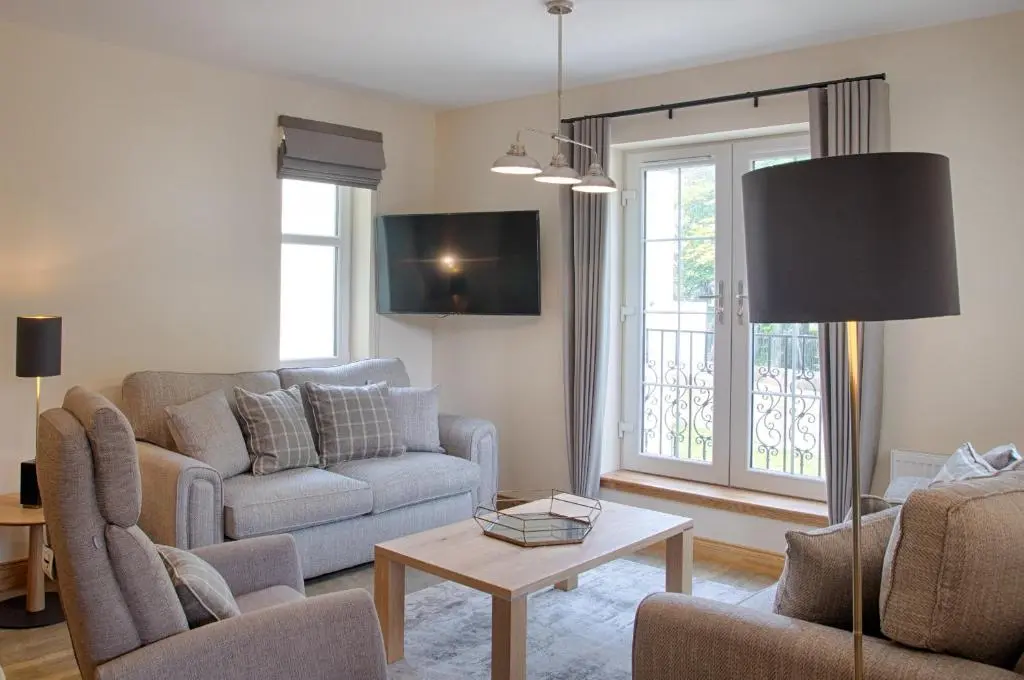 a living room with a couch and a table at Royal Golf Apartments in Dornoch