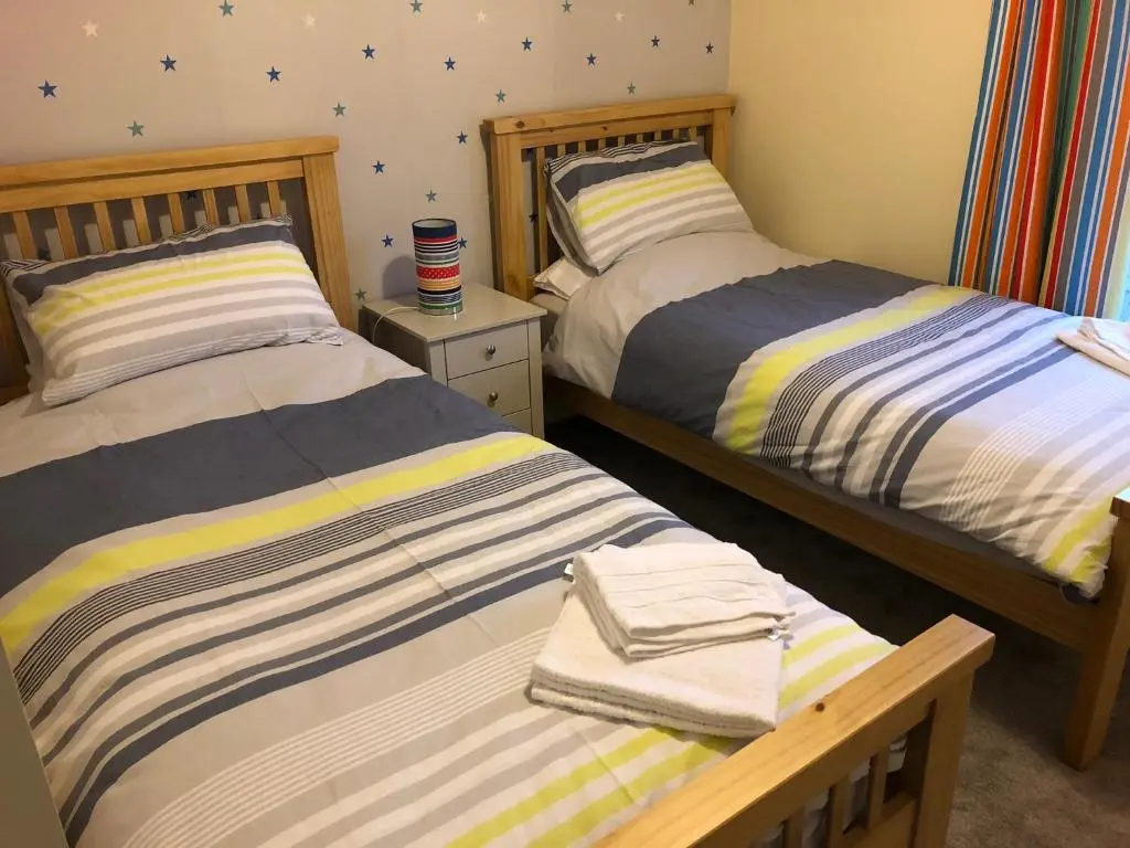 two beds sitting next to each other in a bedroom at 41 Larchwood Drive Holiday Home in Inverness