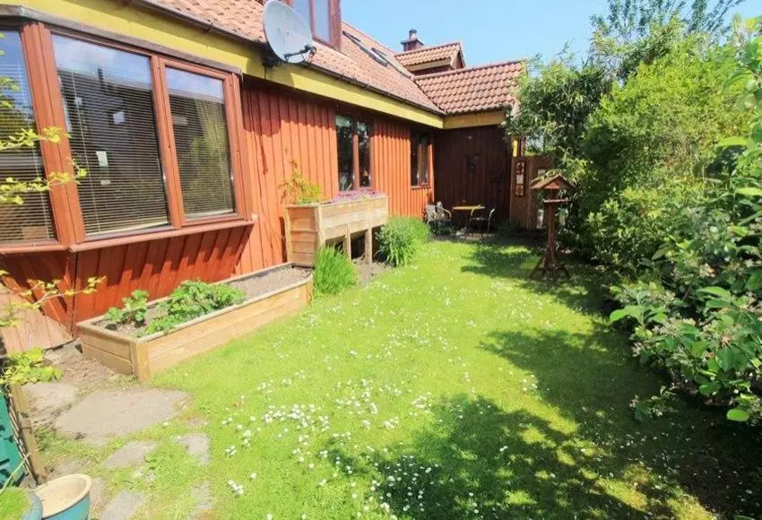 a backyard of a house with a grass yard at Sunflower Bed & Breakfast in Findhorn