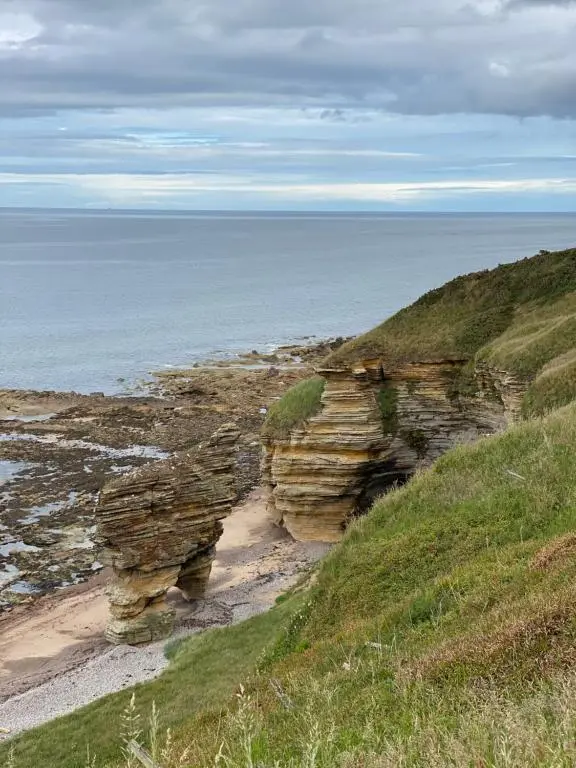 a view of a rocky shoreline with the ocean at 87 Lighthouse View Lodge in Lossiemouth