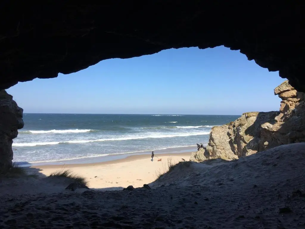 a view of a beach from a cave at 87 Lighthouse View Lodge in Lossiemouth