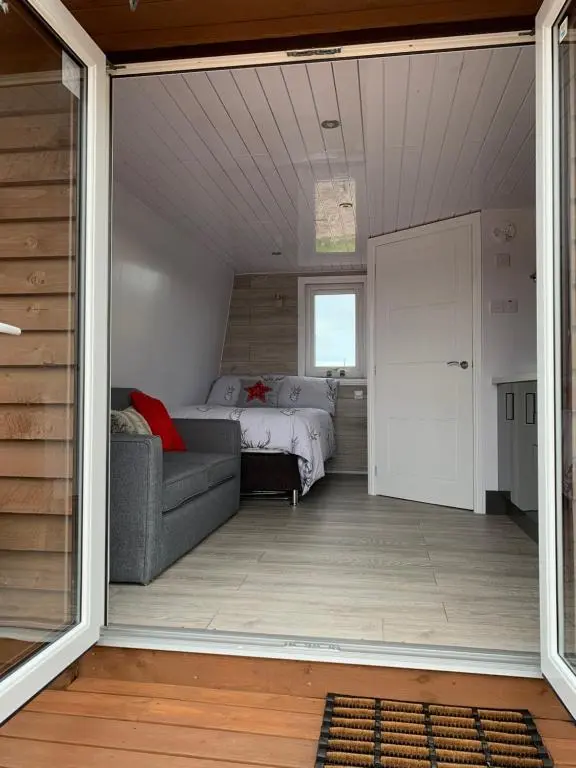 a living room with a bed and a couch at AC/DC Glamping in New Aberdour
