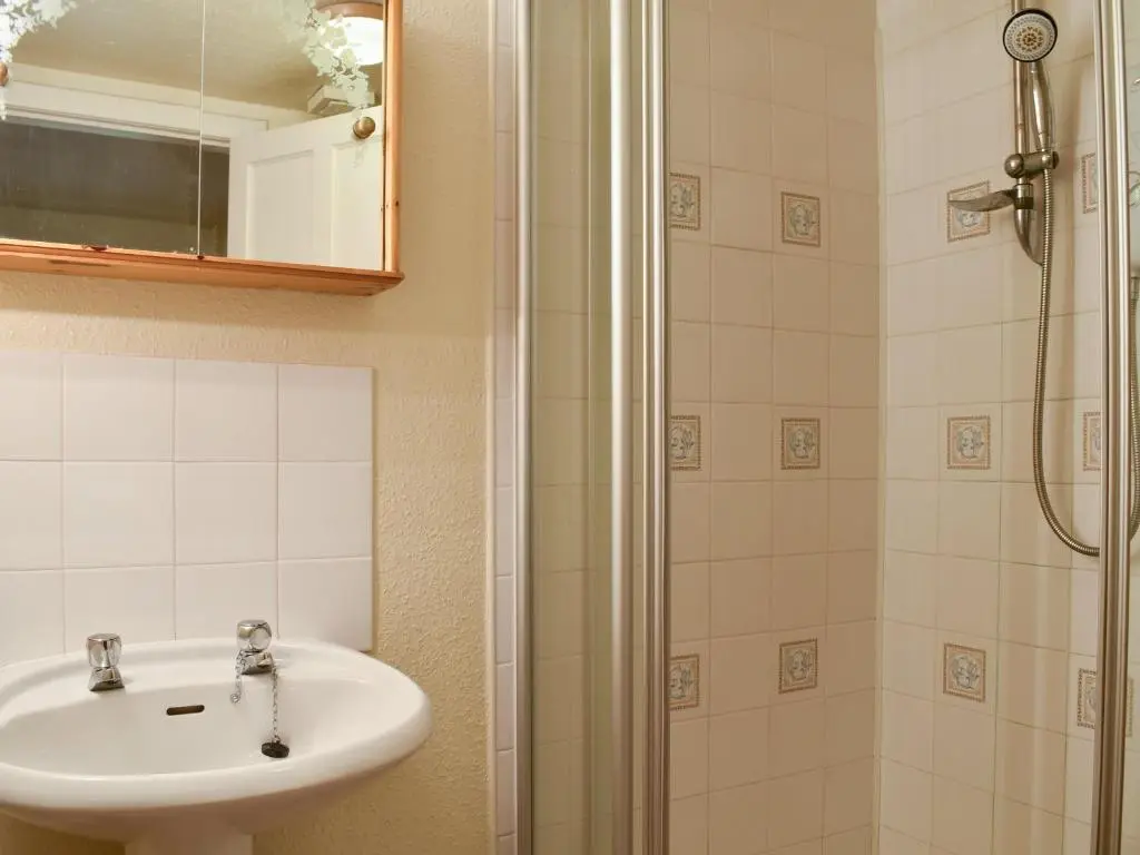 a bathroom with a sink and a shower at Burnmouth in Balnaboth