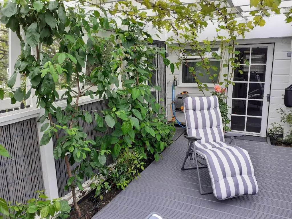 a patio with a chair on a deck at The Treehouse by Airlie in Nairn