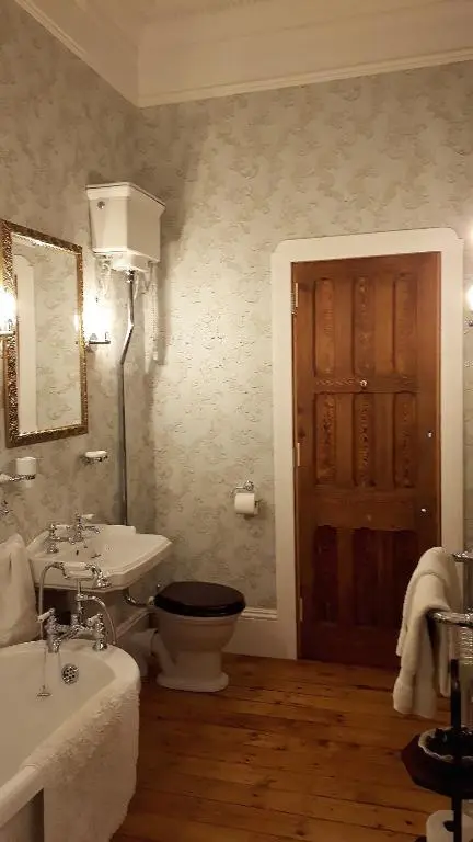 a bathroom with a toilet and a sink and a tub at The Old Convent Holiday Apartments in Fort Augustus
