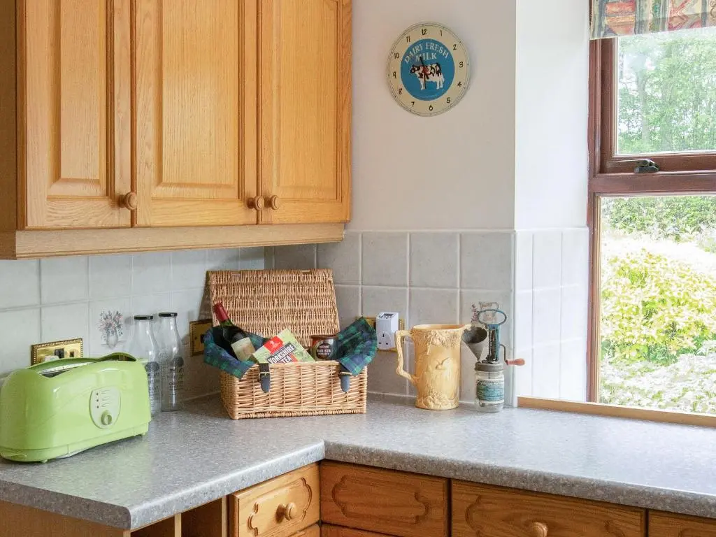 a kitchen counter with a toaster and baskets on it at Middle Lodge in Mintlaw