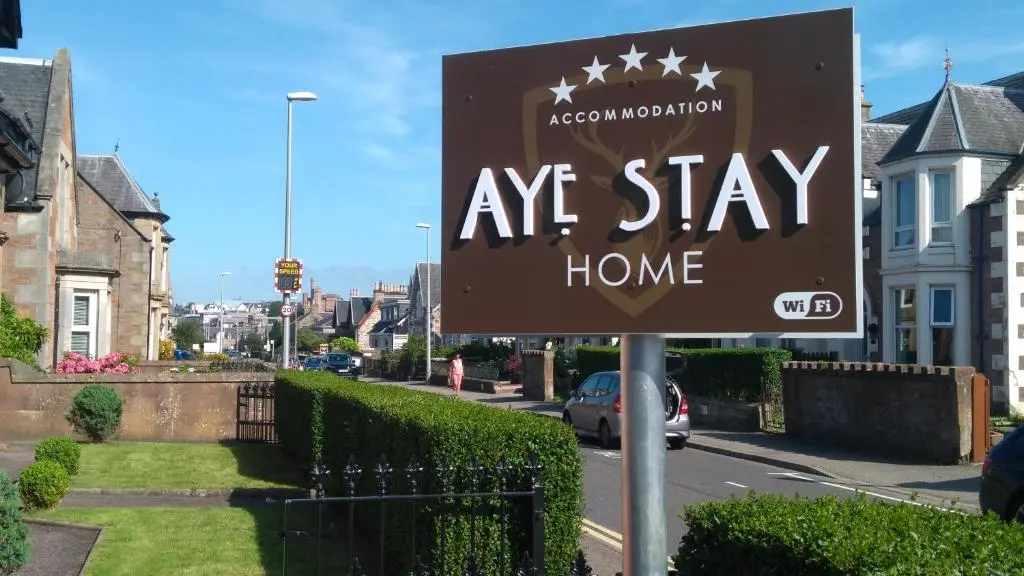 a sign for aagency stay home in a residential street at Aye Stay Home, city centre in Inverness