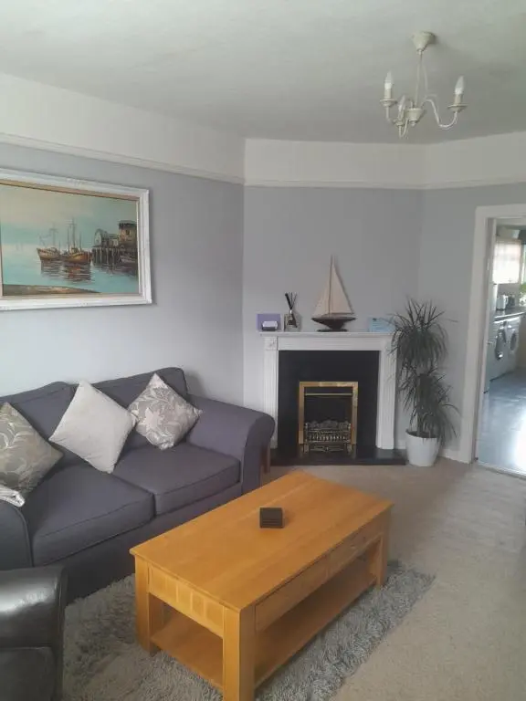 a living room with a couch and a coffee table at WELCOMEHOUSE close to east beach, shops, restaurants and RAF base in Lossiemouth