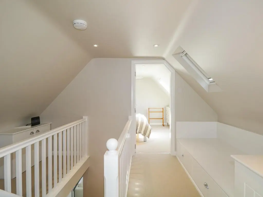 a white staircase in a home with a white ceiling at 36 Sandend Village in Banff