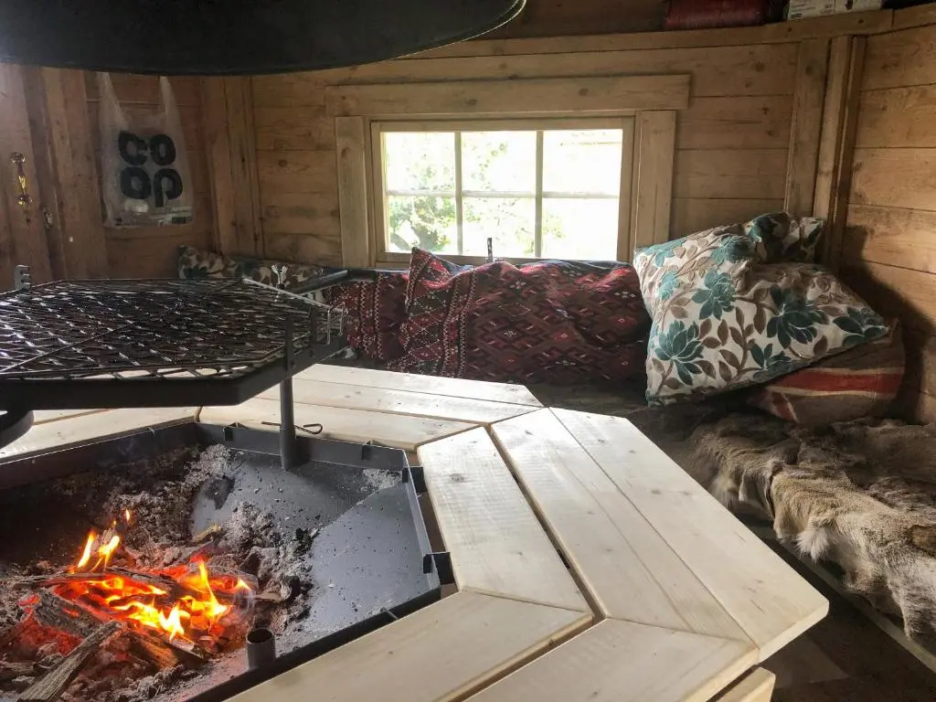 a living room with a fireplace and a couch at Nan's Cottage in Beauly