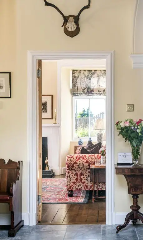 a living room with a couch and a window at The Old Manse, Loch Ness (highland-escape) in Inverness