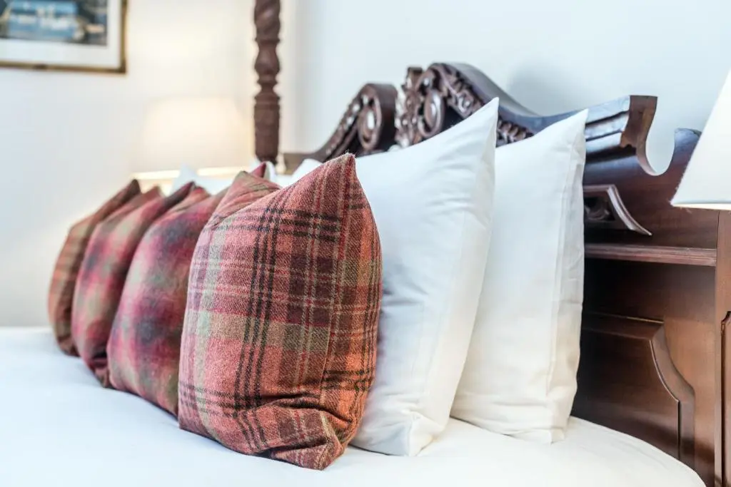 a row of pillows sitting on top of a bed at The Old Manse, Loch Ness (highland-escape) in Inverness