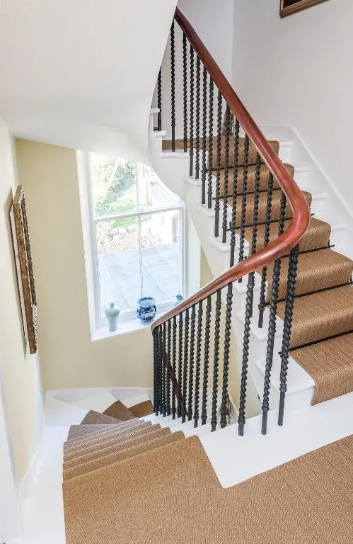 a staircase in a home with white walls and a window at The Old Manse, Loch Ness (highland-escape) in Inverness