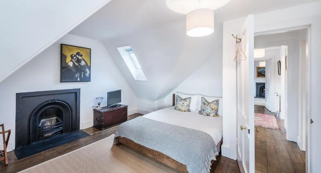 a bedroom with a bed and a fireplace at The Old Manse, Loch Ness (highland-escape) in Inverness