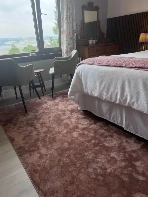 a bedroom with a bed and a desk and a window at Black Isle View in Dingwall