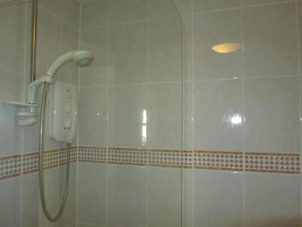 a shower with a phone in a bathroom at River Walk Inverness in Inverness