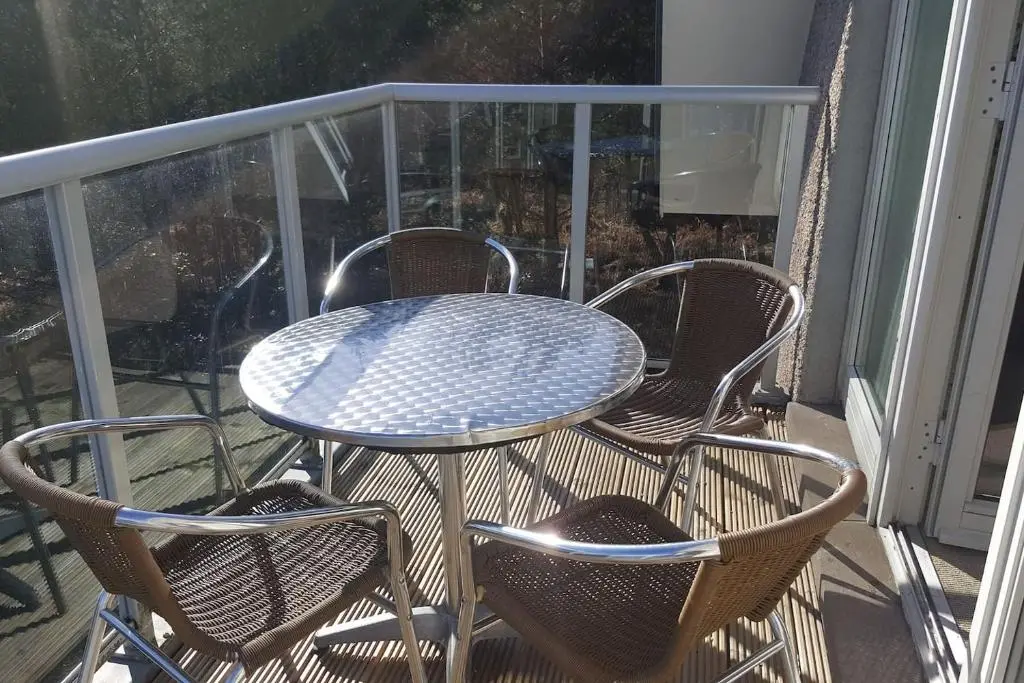 a table and two chairs on a balcony at Inchmarlo Golf Resort, Banchory Villa 26 AS 00266F in Banchory