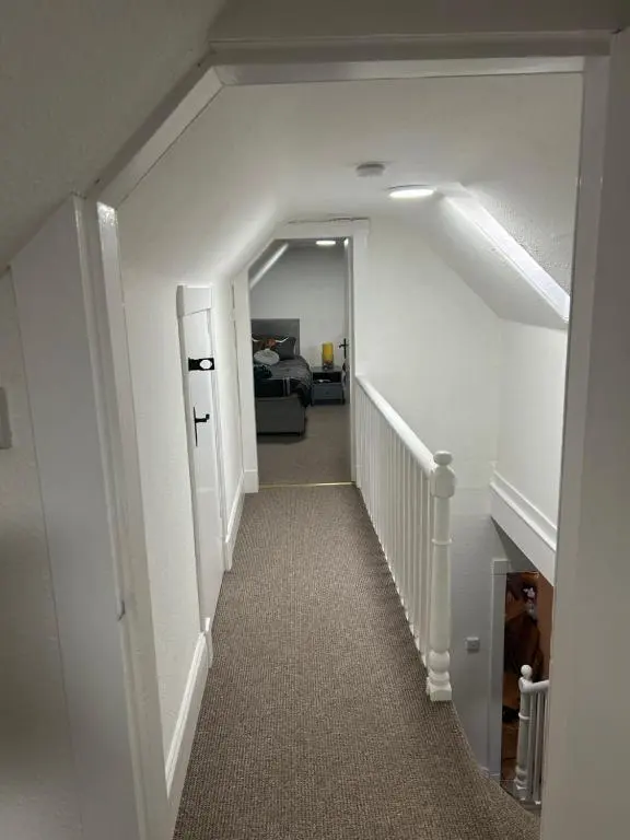 a hallway with a stairway leading to a bedroom at Mortlach Cottage in Dufftown