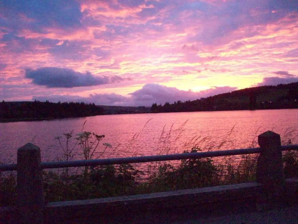 a sunset over a large body of water at Lairg Highland Hotel in Lairg